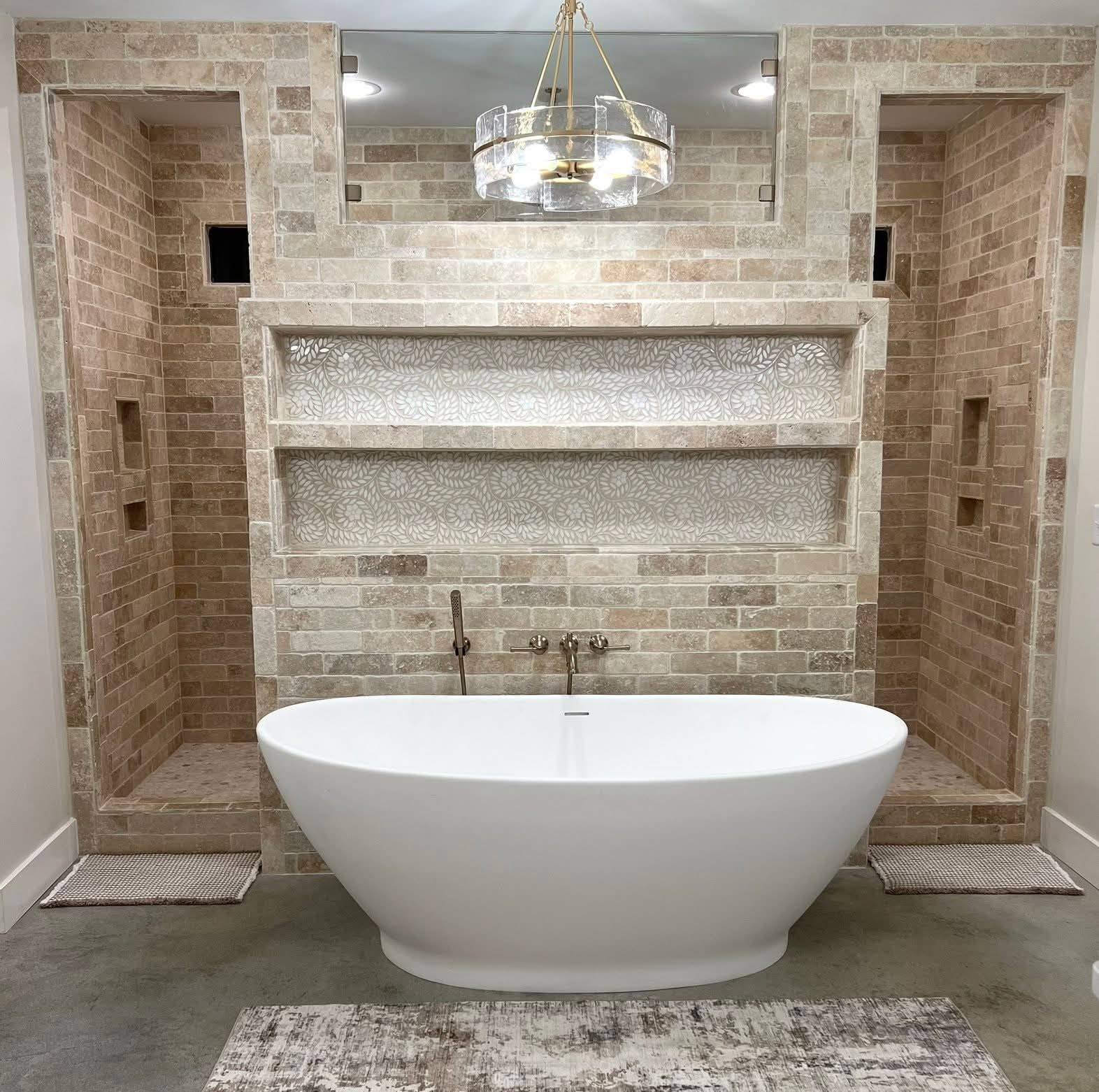 Luxury master bathroom with freestanding soaking tub and travertine tile — installed by Burnette Flooring